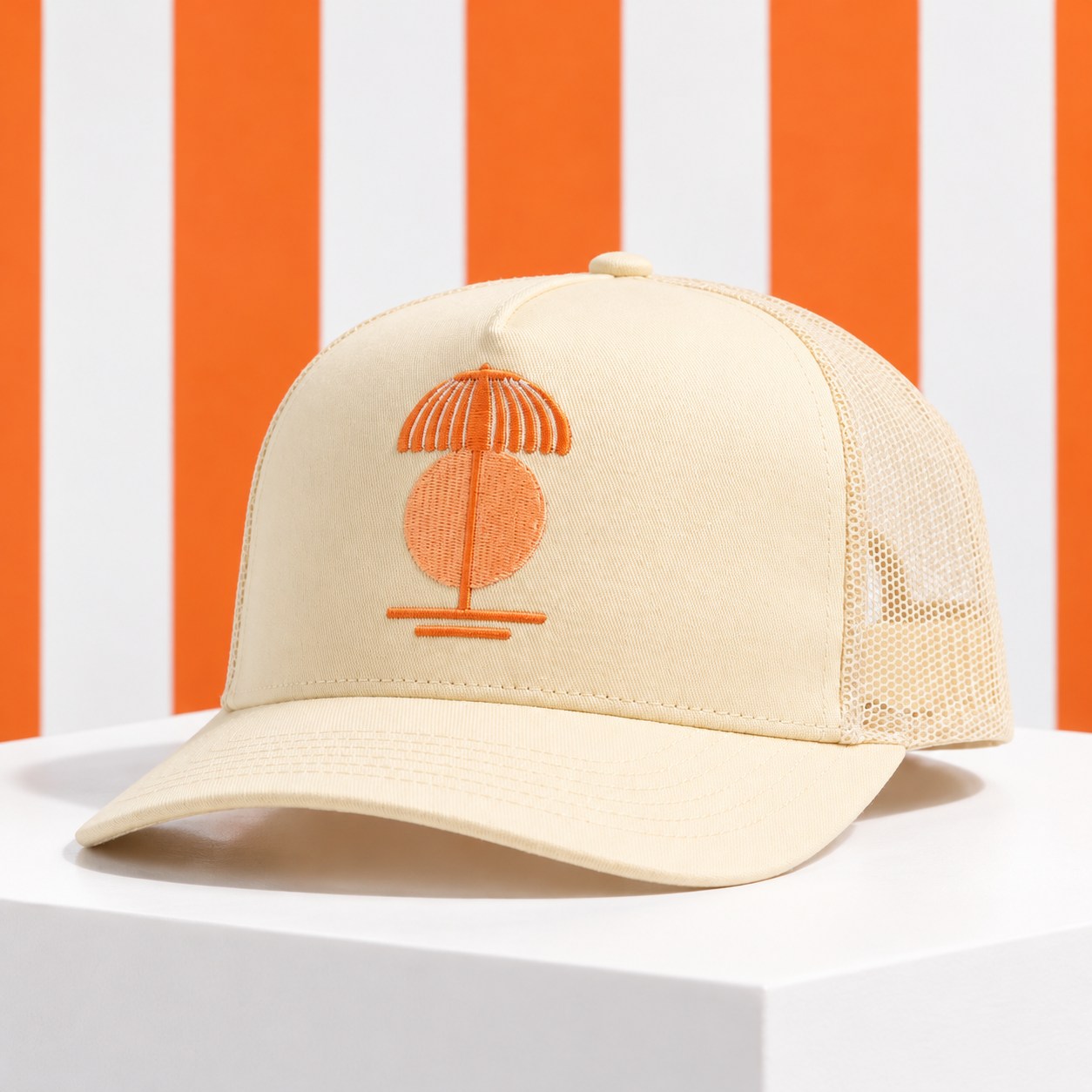 The Arienzo cream cap with orange umbrella embroidery — AI studio campaign styling